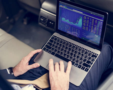 Man looking at data on a laptop